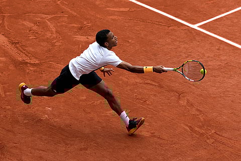 Felix Auger-Aliassime plays a shot against Carlos Alcaraz